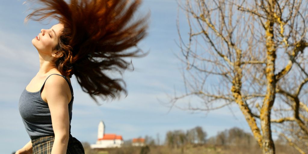a person with the hair blowing in the wind